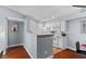 Updated kitchen featuring white cabinets, modern appliances, and a breakfast bar with hardwood floors at 231 W Horizon Ridge Pkwy # 1228, Henderson, NV 89012