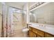 Cozy bathroom with a shower/tub combination, wooden vanity, and a large mirror at 2520 Palmridge Dr, Las Vegas, NV 89134