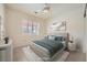 Comfortable bedroom with neutral colors, large window with shutters, and tiled floors at 2520 Palmridge Dr, Las Vegas, NV 89134