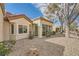 Stunning exterior featuring a neutral stucco finish, tile roof, beautiful windows, and desert landscaping at 2520 Palmridge Dr, Las Vegas, NV 89134