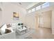 Bright living room featuring tile flooring, clerestory windows, and stylish furnishings at 2520 Palmridge Dr, Las Vegas, NV 89134