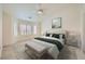 Bright staged main bedroom featuring plush bedding, large windows, and neutral decor at 2520 Palmridge Dr, Las Vegas, NV 89134