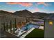Aerial view of backyard oasis featuring a pool, spa, patio, and desert landscaping against a mountain backdrop at 2601 Nevada Agave Ln, Las Vegas, NV 89138
