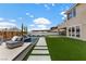 Spacious backyard featuring a pristine pool, manicured lawn, and stylish patio, perfect for outdoor living and entertaining at 2601 Nevada Agave Ln, Las Vegas, NV 89138