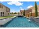 Stunning backyard pool featuring cascading water, desert landscaping, and an attached home with desert views at 2601 Nevada Agave Ln, Las Vegas, NV 89138