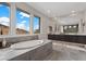 Luxurious bathroom features a soaking tub with scenic mountain views and a double vanity at 2601 Nevada Agave Ln, Las Vegas, NV 89138