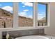 Bathroom view showcasing soaking tub with tile surround and a scenic mountain view through large windows at 2601 Nevada Agave Ln, Las Vegas, NV 89138
