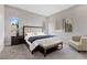 Serene bedroom showcases a tufted headboard, plush carpet, and large windows with neighborhood views at 2601 Nevada Agave Ln, Las Vegas, NV 89138
