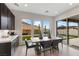 Bright dining area with modern cabinets, light floors, and views of the outdoor space through large windows at 2601 Nevada Agave Ln, Las Vegas, NV 89138