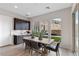 This light filled dining room features dark wood cabinets and a view of the outdoor living space at 2601 Nevada Agave Ln, Las Vegas, NV 89138