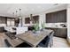 An open-concept dining area features dark wood cabinets, stone countertops and modern decor at 2601 Nevada Agave Ln, Las Vegas, NV 89138