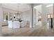 Open dining room with hardwood floors, featuring a chandelier, and views into other areas of the home at 2601 Nevada Agave Ln, Las Vegas, NV 89138