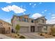 Contemporary two-story home with a three-car garage and desert landscaping, offering modern curb appeal at 2601 Nevada Agave Ln, Las Vegas, NV 89138