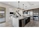 Modern kitchen with stainless steel appliances, an island with seating, and access to the living room at 2601 Nevada Agave Ln, Las Vegas, NV 89138