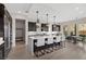 A modern kitchen features dark wood cabinets, stainless steel appliances, and a large island with seating at 2601 Nevada Agave Ln, Las Vegas, NV 89138