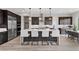 An open kitchen features stainless steel appliances, an island with barstool seating and dark wood cabinetry at 2601 Nevada Agave Ln, Las Vegas, NV 89138