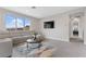 Relaxing living room with modern sofa, stylish rug, and a large window providing natural light at 2601 Nevada Agave Ln, Las Vegas, NV 89138
