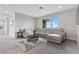 Inviting living room with a comfortable sectional sofa, stylish rug, and natural light at 2601 Nevada Agave Ln, Las Vegas, NV 89138