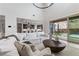 Spacious living room with hardwood flooring, open floor plan, and sliding doors leading to outdoor pool area at 2601 Nevada Agave Ln, Las Vegas, NV 89138