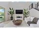 Living room with a tiled fireplace, large windows, and comfortable seating arrangements at 2601 Nevada Agave Ln, Las Vegas, NV 89138