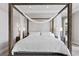 Bright main bedroom featuring a stylish four-poster bed, side tables, and a minimalist design at 2601 Nevada Agave Ln, Las Vegas, NV 89138