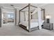 Spacious main bedroom with a four poster bed, neutral tones, and sitting area at 2601 Nevada Agave Ln, Las Vegas, NV 89138
