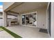 Covered patio with fireplace, outdoor living area, and sliding glass doors to the home's interior at 2601 Nevada Agave Ln, Las Vegas, NV 89138
