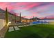 Wide angle view of a pool, spa and outdoor seating area featuring new stone walkway and turf at 2601 Nevada Agave Ln, Las Vegas, NV 89138