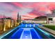 Backyard pool and spa with desert landscaping, built-in BBQ, and covered patio area, perfect for entertaining at 2601 Nevada Agave Ln, Las Vegas, NV 89138