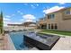 Modern backyard pool, seamlessly integrated into the patio area with a manicured lawn and contemporary architectural details at 2601 Nevada Agave Ln, Las Vegas, NV 89138