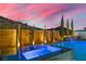 Outdoor spa and pool showcasing a modern wooden fence design with stylish lighting and desert accents at 2601 Nevada Agave Ln, Las Vegas, NV 89138