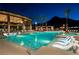 Inviting pool area with palm trees, lounge chairs, and a modern clubhouse for community enjoyment and relaxation at 2601 Nevada Agave Ln, Las Vegas, NV 89138