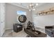 Stylish sitting room features unique decor and comfortable leather armchairs on light wood flooring at 2601 Nevada Agave Ln, Las Vegas, NV 89138