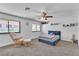 Well-lit bedroom with chair and ottoman, plush carpet, and ample natural light at 2749 Heritage Cir, Las Vegas, NV 89121
