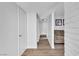 Hallway featuring modern flooring, white doors, and ample natural light with access to the living area at 2749 Heritage Cir, Las Vegas, NV 89121