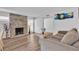 Inviting living room featuring a stone fireplace, ample natural light, and modern flooring at 2749 Heritage Cir, Las Vegas, NV 89121