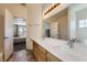 Bright bathroom featuring a double sink vanity, large mirror, and neutral color palette at 2761 Red Vista Ct, Henderson, NV 89074