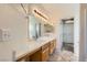 Bathroom with double sinks, wooden cabinets, and walk-in closet at 2761 Red Vista Ct, Henderson, NV 89074