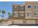 Multi-story home featuring a garage door, desert landscaping and a well-maintained exterior at 2761 Red Vista Ct, Henderson, NV 89074