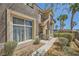 Townhouse showcasing manicured bushes, walkway, large window, and stone design elements at 2761 Red Vista Ct, Henderson, NV 89074