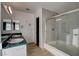 A luxurious bathroom showcases a glass-enclosed shower, tiled backsplash, and ample counter space at 335 Greenbriar Townhouse Way, Las Vegas, NV 89121