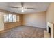 Bedroom features a ceiling fan, carpet flooring, and a fireplace at 335 Greenbriar Townhouse Way, Las Vegas, NV 89121
