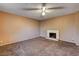 Bedroom featuring carpet flooring, ceiling fan, and a cozy fireplace at 335 Greenbriar Townhouse Way, Las Vegas, NV 89121