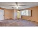 A spacious bedroom features carpeted floors, a ceiling fan, and a window with bright natural light at 335 Greenbriar Townhouse Way, Las Vegas, NV 89121