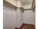 A walk-in closet offers ample storage with shelving and a neutral color palette at 335 Greenbriar Townhouse Way, Las Vegas, NV 89121