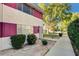 Street view featuring the home's facade, trimmed hedges, and pathway to the front door at 335 Greenbriar Townhouse Way, Las Vegas, NV 89121