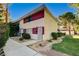 Inviting exterior view showcasing the home's facade, landscaped yard, and walkway at 335 Greenbriar Townhouse Way, Las Vegas, NV 89121