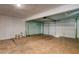 Spacious garage with painted walls, concrete floor, and a white garage door with metal fixtures at 335 Greenbriar Townhouse Way, Las Vegas, NV 89121