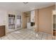Kitchen with tile floors, laundry area, access to backyard, and neutral colored walls at 335 Greenbriar Townhouse Way, Las Vegas, NV 89121