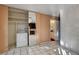 The kitchen provides access to a laundry room and a half bath, with white brick accents at 335 Greenbriar Townhouse Way, Las Vegas, NV 89121
